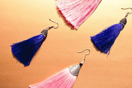 Fashion earrings tassels. Two pairs of pink and blue earrings tassle. Fashion concept.の写真素材