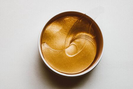 Hydrogel golden cosmetic eye patch jar. Cosmetic product for problem skin.の写真素材