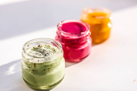 Three jars full of multi colored honey souffle , mix taste.の写真素材