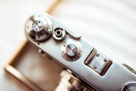 Old retro camera on vintage wooden background