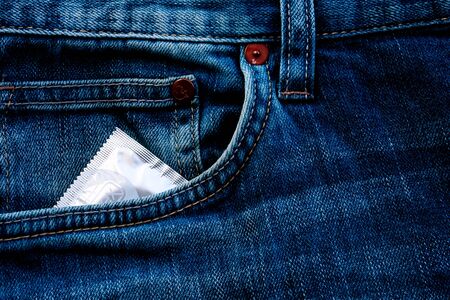 Blue jeans hip-pocket with condom in it.の写真素材