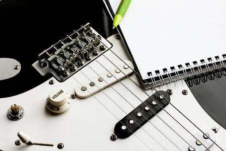 Top view of instrument music recording background concept.Flat lay the pen and notepad on classic...