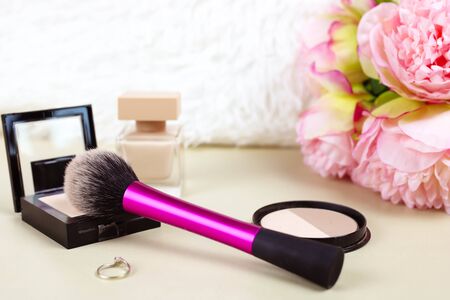 Cosmetic set with brushes and fake eye lashes with make up bag, artificial red rose and woman's accessoryの写真素材