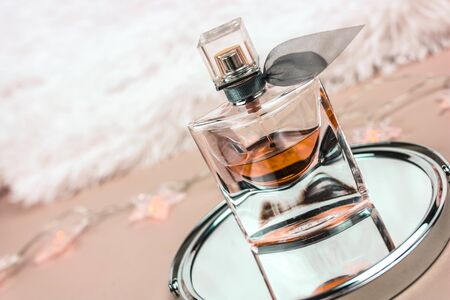 Silhouette of perfume bottle on a white backdrop