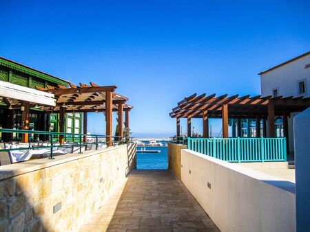 The view between buildings down to the mediterranean sea from a small footpath in Limassol Marina Cyprus..の写真素材