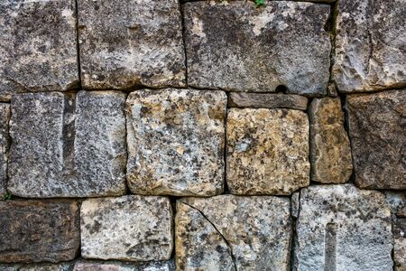 A masonry wall of multicolored stones or blocks. Stone wall textureの写真素材