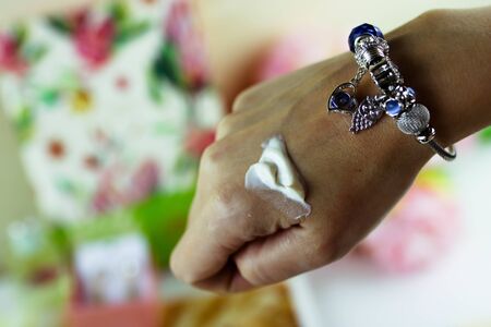 Beauty women hand cream on hands. Woman hands applying moisturizing cream to her skin. Beautiful woman hands with cream cosmetic. Female hands applying cream and lotion. Hand skin care.の写真素材