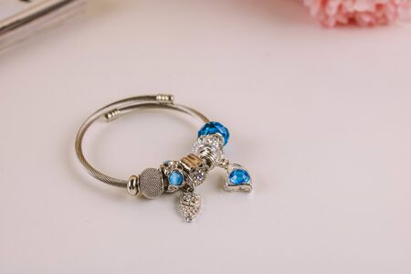 Silver jewelry bracelet with beads and stnes on a white background.の写真素材