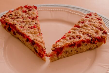 Two slices of baked homemade pie with berries on the white ceramic plate. Sweet food.の写真素材