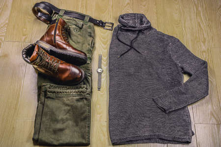 Top view of man's casual clothing set on wooden background. High quality photo
