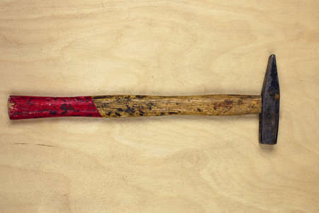 Old rusty hummer on wooden background. View from above