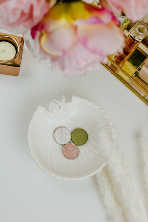 Makeup products eyeshadows on white decorative plate and white background.の写真素材