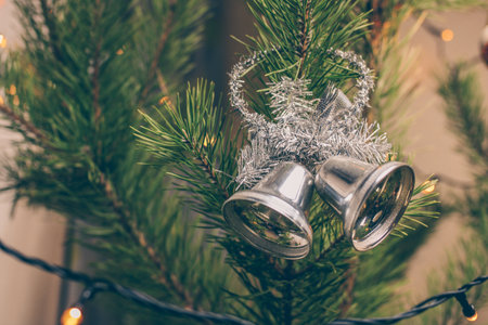 Christmas bells and fir-tree branch on gray background. New year 2022.の写真素材