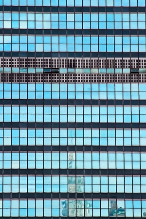 The United Nations building glass window with Chrysler building reflection  in New York Cityの写真素材