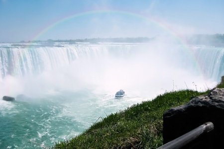 Beautiful rainbow over tour boat at Niagara falls horseshoeの写真素材