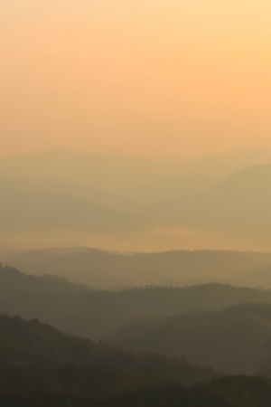 Morning mist and layers of tropical mountain at Huai Nam Dang National Park in Mae Hong Son, Thailand の写真素材
