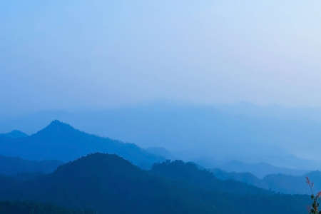 Morning mist and layers of tropical mountain at Huai Nam Dang National Park in Mae Hong Son, Thailand の写真素材