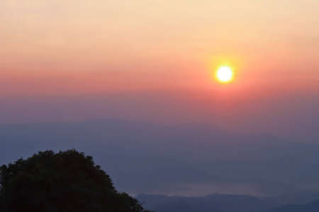 Sunrise over morning mist and layers of tropical mountain at Huai Nam Dang National Park, Mae Hong Son, Thailandの写真素材
