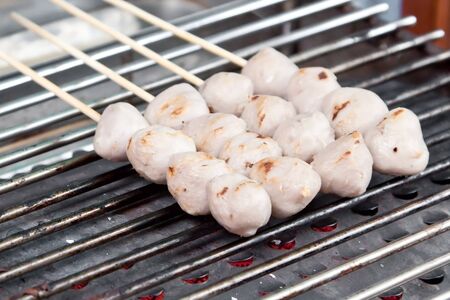 Street food meatball sticks on the grill