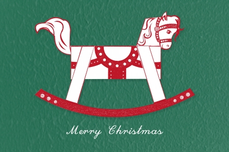 Abstract red and white rocking horse Christmas greetings on green backgroundの写真素材