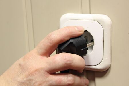 Electric socket. Hand inserted electrical plug. 
