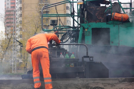 Road workers. The asphalt. 