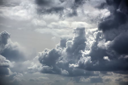 Dark rain clouds in the sky on a sunny day.の写真素材