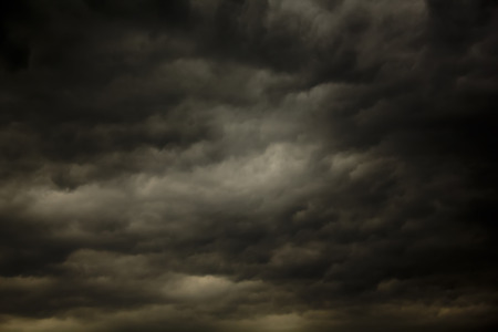Dark rain clouds in the sky on a sunny day.