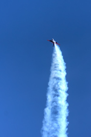 The plane flying in the cloudy sky.の写真素材