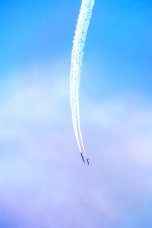 The plane flying in the cloudy sky.の写真素材