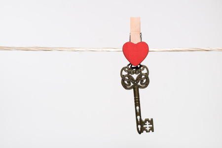clothes pins with small hearts on white backgroudの写真素材