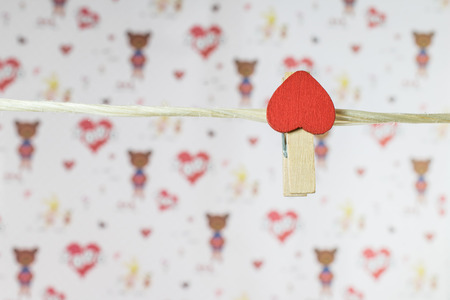 clothes pins with small hearts on white backgroudの写真素材