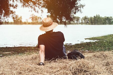 A  man relaxing on the waterfront,enjoying good day and sun.