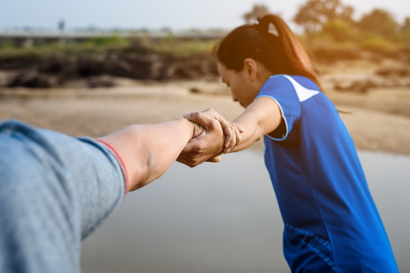 The man gives helping hand outstretched for salvationの写真素材