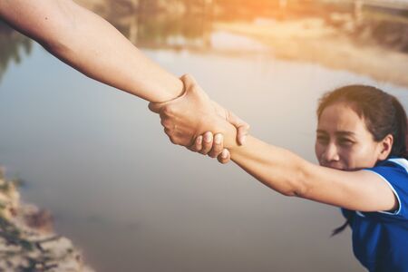 The man gives helping hand outstretched for salvationの写真素材