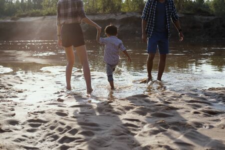 Happy loving family, Parents and children on the beach,playing outdoors.の写真素材