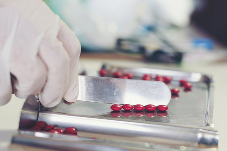 Counting tablets medical pills on stainless steel tray.Health care and medical conceptの写真素材