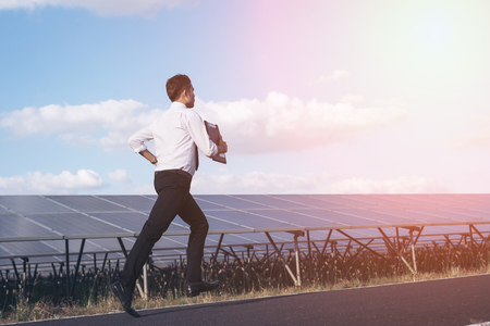 Engineers are aiming to run towards their goals in the solar panel.の写真素材