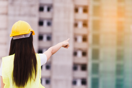 Woman engineer Pointing to the building being under construction, construction and architecture concept.の写真素材