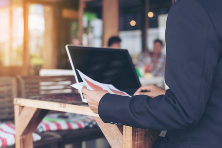 Young businesswoman working at the cafe with laptop and documents. の写真素材