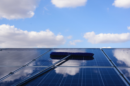 Workers or engineers are cleaning cleaning  photovoltaic panels in the Solar power plant ,Clean...