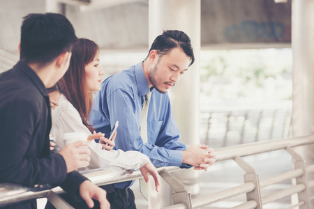Male business man is saddled with business failure. And friends who are giving strength in the moment of discouragement.の写真素材