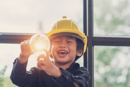 Funny Asian boys hold a light bulb that shines in their hands.

Sustainable alternative concept work,Child with future of alternative energy and sustainable energy,Eco-Friendly and Pure energy Conceptの写真素材