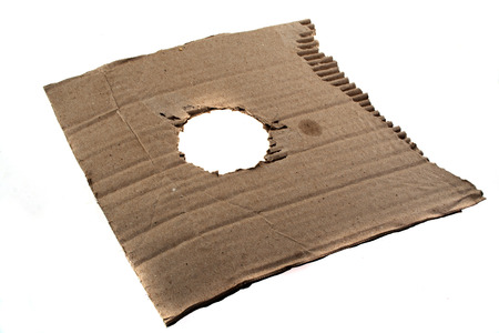 paper with a hole isolated on a black backgroundの写真素材