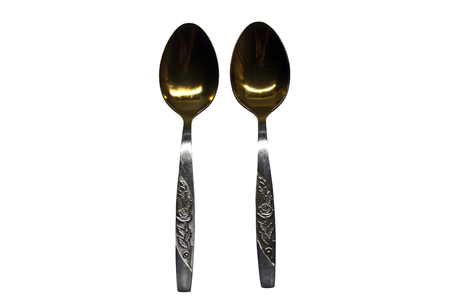 iron spoon isolated on black backgroundの写真素材
