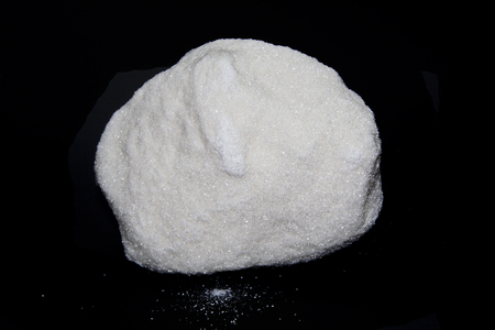 a piece of sugar isolated on a black backgroundの写真素材
