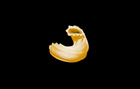 macaroni isolated on black backgroundの写真素材