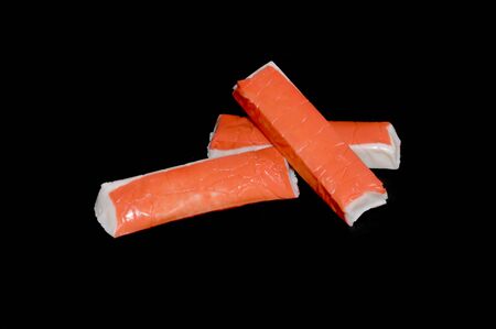 crab sticks isolated on black backgroundの写真素材