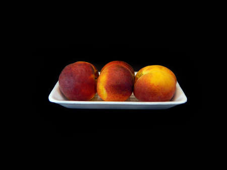 red peach isolated on black backgroundの写真素材