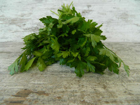 parsley isolated on wooden backgroundの写真素材